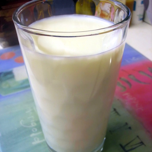 Glass_of_milk_on_tablecloth.jpg